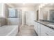 Relaxing primary bath featuring soaking tub, glass shower, and dual vanities at 2431 Kingston Heath Way, Marietta, GA 30008