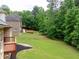 Large backyard with a brick home featuring multiple decks and levels, perfect for outdoor living at 3512 Centerville Rosebud Rd, Snellville, GA 30039