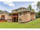 Aerial view of a brick home with a spacious backyard, decks, and lush landscaping at 3512 Centerville Rosebud Rd, Snellville, GA 30039