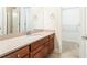 Bright bathroom with cherry wood vanity, neutral granite counters, walk-in closet, and sleek fixtures at 3512 Centerville Rosebud Rd, Snellville, GA 30039