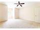 Spacious bedroom features a light colored carpet, white walls, a ceiling fan, and a window at 3512 Centerville Rosebud Rd, Snellville, GA 30039
