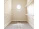 This walk-in closet features carpeted floors, white wire shelving and a round window for natural light at 3512 Centerville Rosebud Rd, Snellville, GA 30039