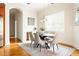 Dining room with large window and table set for six in neutral tones at 3512 Centerville Rosebud Rd, Snellville, GA 30039