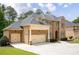 Stately brick home boasts a three-car garage, lush lawn, and classic architectural design at 3512 Centerville Rosebud Rd, Snellville, GA 30039