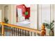 Hallway view of a living space with a tall red accent wall, light wood cabinet, and green plant at 3512 Centerville Rosebud Rd, Snellville, GA 30039