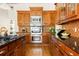 A kitchen with wood cabinets, stainless steel appliances, and granite countertops at 3512 Centerville Rosebud Rd, Snellville, GA 30039