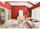 Comfortable living room with white sofa, red walls, light wood cabinet and a round rattan coffee table at 3512 Centerville Rosebud Rd, Snellville, GA 30039