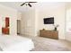 Spacious main bedroom with a large window, TV, and entry to main bathroom with wooden cabinets at 3512 Centerville Rosebud Rd, Snellville, GA 30039