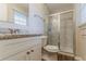 Bathroom features a granite countertop, vanity, and shower with glass doors at 545 Fayetteville Rd, Fairburn, GA 30213