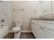 Bathroom showcasing marble accent wall and countertop, toilet with seat cover, and vanity at 545 Fayetteville Rd, Fairburn, GA 30213
