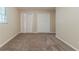 Bedroom featuring neutral walls, carpet, and double closet doors at 545 Fayetteville Rd, Fairburn, GA 30213