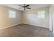 Bedroom with ceiling fan, carpet, neutral walls, and windows at 545 Fayetteville Rd, Fairburn, GA 30213
