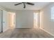 Bedroom featuring carpet, doors to additional rooms, and ceiling fan at 545 Fayetteville Rd, Fairburn, GA 30213