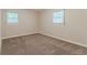 Bedroom with beige walls, carpet, and windows letting in light at 545 Fayetteville Rd, Fairburn, GA 30213