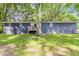 The back of this brick house has a small wooden deck and a grassy yard with some trees providing shade at 545 Fayetteville Rd, Fairburn, GA 30213