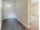 Entry way features hardwood floors, and a view into the hallway with carpeted floors at 545 Fayetteville Rd, Fairburn, GA 30213