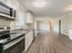 Spacious kitchen with stainless steel appliances, light countertops and hardwood flooring at 545 Fayetteville Rd, Fairburn, GA 30213