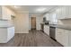 Kitchen featuring granite countertops, stainless steel appliances, white cabinetry and plank flooring at 545 Fayetteville Rd, Fairburn, GA 30213