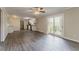 Open living room and kitchen featuring hardwood flooring and sliding glass door to deck at 545 Fayetteville Rd, Fairburn, GA 30213