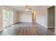 Open living room with hardwood flooring and sliding glass door to deck at 545 Fayetteville Rd, Fairburn, GA 30213