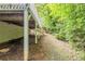 View alongside the deck of the home, showing a small path to the backyard surrounded by greenery at 733 San Fernando Se Dr, Smyrna, GA 30080