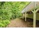 View alongside the deck of the home, showing a small path to the backyard surrounded by greenery at 733 San Fernando Se Dr, Smyrna, GA 30080