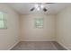 Bedroom featuring gray carpet and ceiling fan with window providing natural light at 733 San Fernando Se Dr, Smyrna, GA 30080