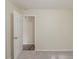 Comfortable bedroom showcasing neutral paint, plush carpet, and an open doorway at 733 San Fernando Se Dr, Smyrna, GA 30080