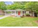 Charming ranch home with a well-manicured lawn, bright red door, and covered parking at 733 San Fernando Se Dr, Smyrna, GA 30080