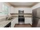 Updated kitchen featuring stainless steel appliances, granite countertops, and sleek white cabinets at 733 San Fernando Se Dr, Smyrna, GA 30080