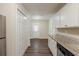 Kitchen featuring modern appliances, ample storage, granite counters, and vinyl plank flooring at 733 San Fernando Se Dr, Smyrna, GA 30080