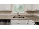 Bright kitchen with a stainless steel sink and granite countertops, illuminated by natural light at 733 San Fernando Se Dr, Smyrna, GA 30080
