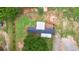Aerial view of property with modern home featuring a metal roof, deck and mature landscaping at 901 N Van Wert Rd, Villa Rica, GA 30180