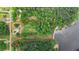 Aerial view of a large property with trees, a home, a barn, and access to a body of water at 901 N Van Wert Rd, Villa Rica, GA 30180