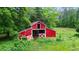 Classic red barn with white trim, featuring a traditional design set against a green backdrop at 901 N Van Wert Rd, Villa Rica, GA 30180