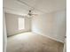 Bedroom showcasing neutral walls, a ceiling fan, and a window providing natural light at 901 N Van Wert Rd, Villa Rica, GA 30180
