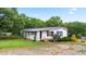 Charming single-story home with green lawn, lush landscaping, and classic black shutters at 901 N Van Wert Rd, Villa Rica, GA 30180