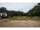 Exterior view of a quaint home with a fenced yard and a storage barn in the back at 901 N Van Wert Rd, Villa Rica, GA 30180