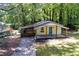 Aerial view of a cozy bungalow style home with a screened in porch surrounded by mature trees at 2917 Reveille Se Cir, Atlanta, GA 30316
