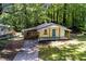 Aerial view of a cozy bungalow style home with a screened in porch surrounded by mature trees at 2917 Reveille Se Cir, Atlanta, GA 30316