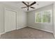 Comfortable bedroom featuring a ceiling fan, closet, and window with a scenic view at 3570 Steve Nw Dr, Marietta, GA 30064
