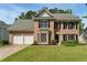 Charming two-story brick home with a well-manicured lawn and a two-car garage at 3570 Steve Nw Dr, Marietta, GA 30064