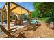 Outdoor space with a pergola, dining area, lounge chairs, grill and a stunning pool with beautiful landscaping at 3707 Lance Bluff Ln, Duluth, GA 30097