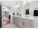 Bathroom with double sinks and gold hardware, soaking tub, glass shower, and a walk-in closet at 3707 Lance Bluff Ln, Duluth, GA 30097