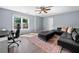 Comfortable bedroom featuring a large window and a cozy seating area with leather couch at 3707 Lance Bluff Ln, Duluth, GA 30097