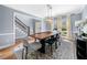 Dining room with modern lighting, hardwood floors, and staircase view at 3707 Lance Bluff Ln, Duluth, GA 30097