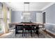 Dining room with modern lighting, neutral walls, and hardwood floors at 3707 Lance Bluff Ln, Duluth, GA 30097