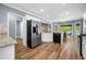 Eat-in kitchen featuring stainless steel appliances, granite countertops, and hardwood floors at 3707 Lance Bluff Ln, Duluth, GA 30097