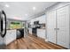 Bright eat-in kitchen with white cabinets, stainless steel appliances, and hardwood floors at 3707 Lance Bluff Ln, Duluth, GA 30097