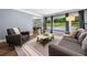 Inviting living room with gray furniture and views of the serene backyard at 3707 Lance Bluff Ln, Duluth, GA 30097